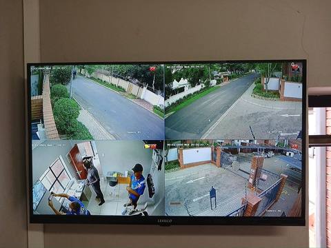 CCTV monitor showing four camera feeds from a JNT installation